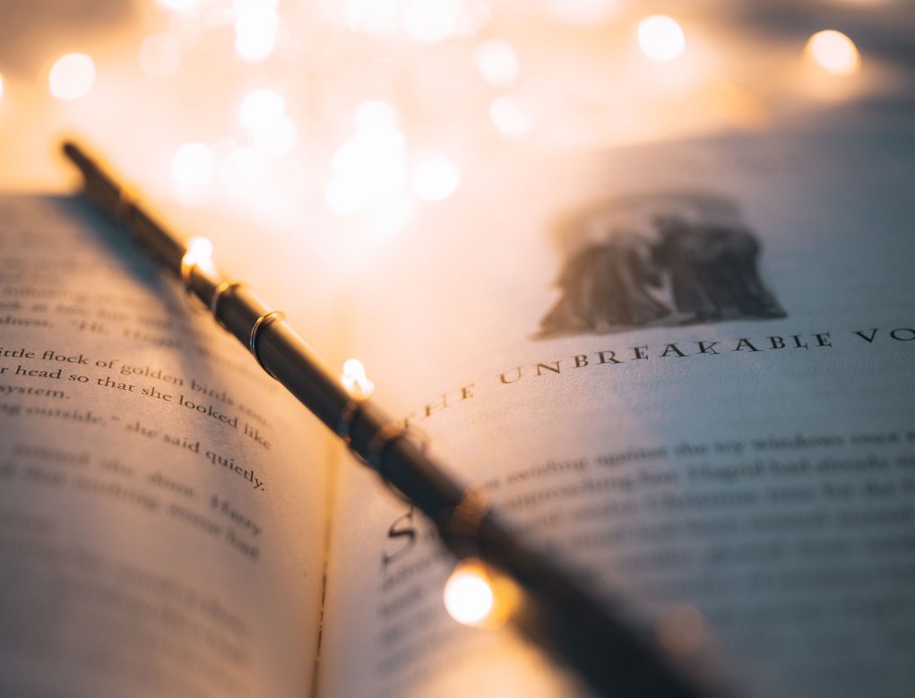 Zauberstab mit einer Lichterkette auf einem Buch